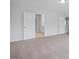 A carpeted bedroom with white trim and a bathroom entrance at 173 Wild Turkey Way, Lillington, NC 27546