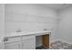 Laundry room with ample counter space, sink, white cabinets, and wire shelving at 173 Wild Turkey Way, Lillington, NC 27546