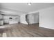 Open-concept living area with wood floors, bright white walls, and seamless flow into kitchen and dining spaces at 173 Wild Turkey Way, Lillington, NC 27546
