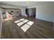 Open living area with laminate flooring, lots of light, and access to kitchen at 173 Wild Turkey Way, Lillington, NC 27546