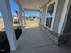 Covered porch with view of lawn, siding, and brick foundation at 173 Wild Turkey Way, Lillington, NC 27546