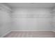 Spacious walk-in closet with white wire shelving and neutral carpeting at 173 Wild Turkey Way, Lillington, NC 27546