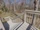 Back deck with wooden railing and steps leading to a wooded backyard at 1961 Indianwood Ct, Raleigh, NC 27604
