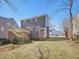 An elevated back deck with gray siding home and treelined view at 1961 Indianwood Ct, Raleigh, NC 27604