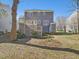 The back exterior view features a staircase to the back deck, and gray siding at 1961 Indianwood Ct, Raleigh, NC 27604