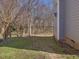 Home's backyard with lawn and wooded surroundings at 1961 Indianwood Ct, Raleigh, NC 27604