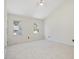 Spacious bedroom with vaulted ceilings, two windows providing natural light, and neutral carpet at 1961 Indianwood Ct, Raleigh, NC 27604