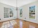 Sunlit dining room featuring hardwood floors, a chandelier, and large windows at 1961 Indianwood Ct, Raleigh, NC 27604