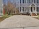 A front exterior features an expansive driveway and a view of the front door at 1961 Indianwood Ct, Raleigh, NC 27604