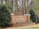 Hedingham Golf & Athletic Club brick entrance sign surrounded by mature trees and landscaping at 1961 Indianwood Ct, Raleigh, NC 27604