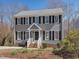 Charming two-story home with gray siding, black shutters, and a welcoming front entrance at 1961 Indianwood Ct, Raleigh, NC 27604
