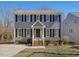 Traditional two-story home with gray exterior, black shutters, and inviting front porch at 1961 Indianwood Ct, Raleigh, NC 27604