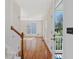 Bright foyer with hardwood floors, a staircase, and a view to the exterior at 1961 Indianwood Ct, Raleigh, NC 27604