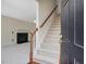 Inviting foyer with staircase and view into the living room with a cozy fireplace at 1961 Indianwood Ct, Raleigh, NC 27604