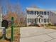 Charming two-story home with a spacious driveway and inviting front porch, framed by mature trees at 1961 Indianwood Ct, Raleigh, NC 27604