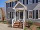 Close-up of the home's entry featuring a brick staircase and a classic black front door at 1961 Indianwood Ct, Raleigh, NC 27604