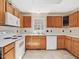 Kitchen with white countertops and appliances, and medium oak cabinets at 1961 Indianwood Ct, Raleigh, NC 27604