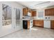 A kitchen with white appliances, tile flooring, oak cabinets, and a glass door at 1961 Indianwood Ct, Raleigh, NC 27604