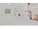 Living room with carpeted floors, a ceiling fan, and hardwood stairs at 1961 Indianwood Ct, Raleigh, NC 27604