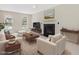 Bright living room featuring neutral paint, fireplace, modern furniture and large windows at 1961 Indianwood Ct, Raleigh, NC 27604
