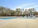 Large swimming pool with a bathhouse and surrounded by mature trees at 1961 Indianwood Ct, Raleigh, NC 27604