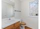 Powder room featuring a wood vanity and hardwood floors, offering a convenient space for guests at 1961 Indianwood Ct, Raleigh, NC 27604