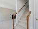 Carpeted staircase with wood railing leading to the upper level and a view of the living room fireplace at 1961 Indianwood Ct, Raleigh, NC 27604