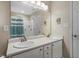 Well-lit bathroom featuring a double sink vanity, a large mirror, and a separate shower with a curtain at 201 Moss Creek Dr, Clayton, NC 27520