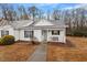 Charming home featuring well-maintained landscaping, a covered porch, and a white exterior at 201 Moss Creek Dr, Clayton, NC 27520