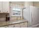 Close-up view of the kitchen counter with granite, white cabinets, and modern appliances at 201 Moss Creek Dr, Clayton, NC 27520