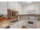 Bright kitchen with white cabinets, granite countertops, and modern appliances at 201 Moss Creek Dr, Clayton, NC 27520
