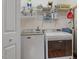 Functional laundry room with washer, dryer, storage shelves and hanging rack for convenience at 201 Moss Creek Dr, Clayton, NC 27520