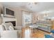 Bright living area featuring a fireplace, hardwood floors, and a view into the kitchen at 201 Moss Creek Dr, Clayton, NC 27520