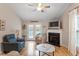 Comfortable living room featuring a fireplace, vaulted ceiling, and access to the outdoor space at 201 Moss Creek Dr, Clayton, NC 27520