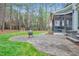 Well-manicured backyard with stone patio, playset and trees at 204 Dartmoor Ln, Raleigh, NC 27614