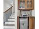This elegant bar area features wooden cabinets, a marble countertop, and a built-in mini fridge, perfect for entertaining at 204 Dartmoor Ln, Raleigh, NC 27614