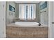 Bathroom featuring a tub with tile surround and modern fixtures at 204 Dartmoor Ln, Raleigh, NC 27614