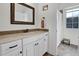 Bathroom with vanity, mirror, white cabinets, granite countertop, mosaic tile backsplash, and walk in shower at 204 Dartmoor Ln, Raleigh, NC 27614
