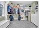 Spacious walk-in closet with custom shelving, ample storage space, hanging clothes and shoe shelves at 204 Dartmoor Ln, Raleigh, NC 27614