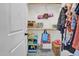 Walk-in closet interior with shelves and rods full of hanging clothes, plus storage for yoga mat and other items at 204 Dartmoor Ln, Raleigh, NC 27614