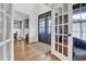 Bright foyer with hardwood floors and elegant glass doors; view to dining room and office at 204 Dartmoor Ln, Raleigh, NC 27614