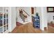 Hallway with hardwood floors and view of staircase and adjacent rooms at 204 Dartmoor Ln, Raleigh, NC 27614