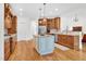 Spacious kitchen with a central island, custom cabinetry, stainless steel appliances, and hardwood floors at 204 Dartmoor Ln, Raleigh, NC 27614