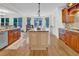 Open kitchen with island, granite countertops, and breakfast nook with wooded view at 204 Dartmoor Ln, Raleigh, NC 27614