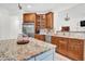 Well-appointed kitchen boasts granite countertops, a stainless steel refrigerator, and custom wood cabinetry at 204 Dartmoor Ln, Raleigh, NC 27614