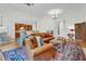 Open-concept living room with leather seating, hardwood floors, and view of the kitchen area perfect for modern living at 204 Dartmoor Ln, Raleigh, NC 27614