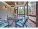 Screened in porch with slate floors and wicker patio furniture at 204 Dartmoor Ln, Raleigh, NC 27614