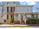 Charming two-story home featuring a mix of siding and brick with a well-manicured front yard and porch at 205 Clancy Cir, Cary, NC 27511