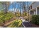 Landscaped front yard with a walkway leading to the house, mature trees, and blooming greenery at 205 Clancy Cir, Cary, NC 27511