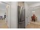 Hallway with stainless refrigerator leading to living room and dining area at 205 Clancy Cir, Cary, NC 27511